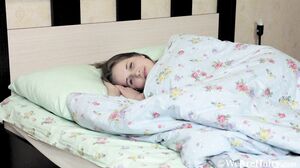 Alice Bright awakens in bed to play naked