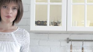 Aimee has fun being naked in her kitchen