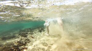 kiss1couple - Handjob on the beach behind the rocks