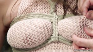 Natural busty slave in heavy bondage