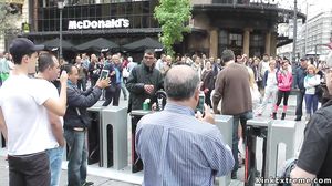 Nude blonde in strait jacket in public