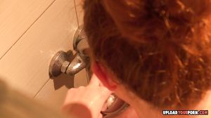 Horny redhead in the shower pleasures herself